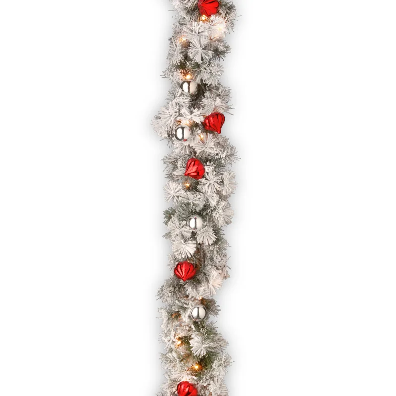 9 ft. Pre-Lit Snowy Bristle Pine Garland with Clear Lights and Ornaments